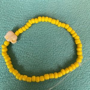 Yellow elephant bracelet made by me with stretchy cord